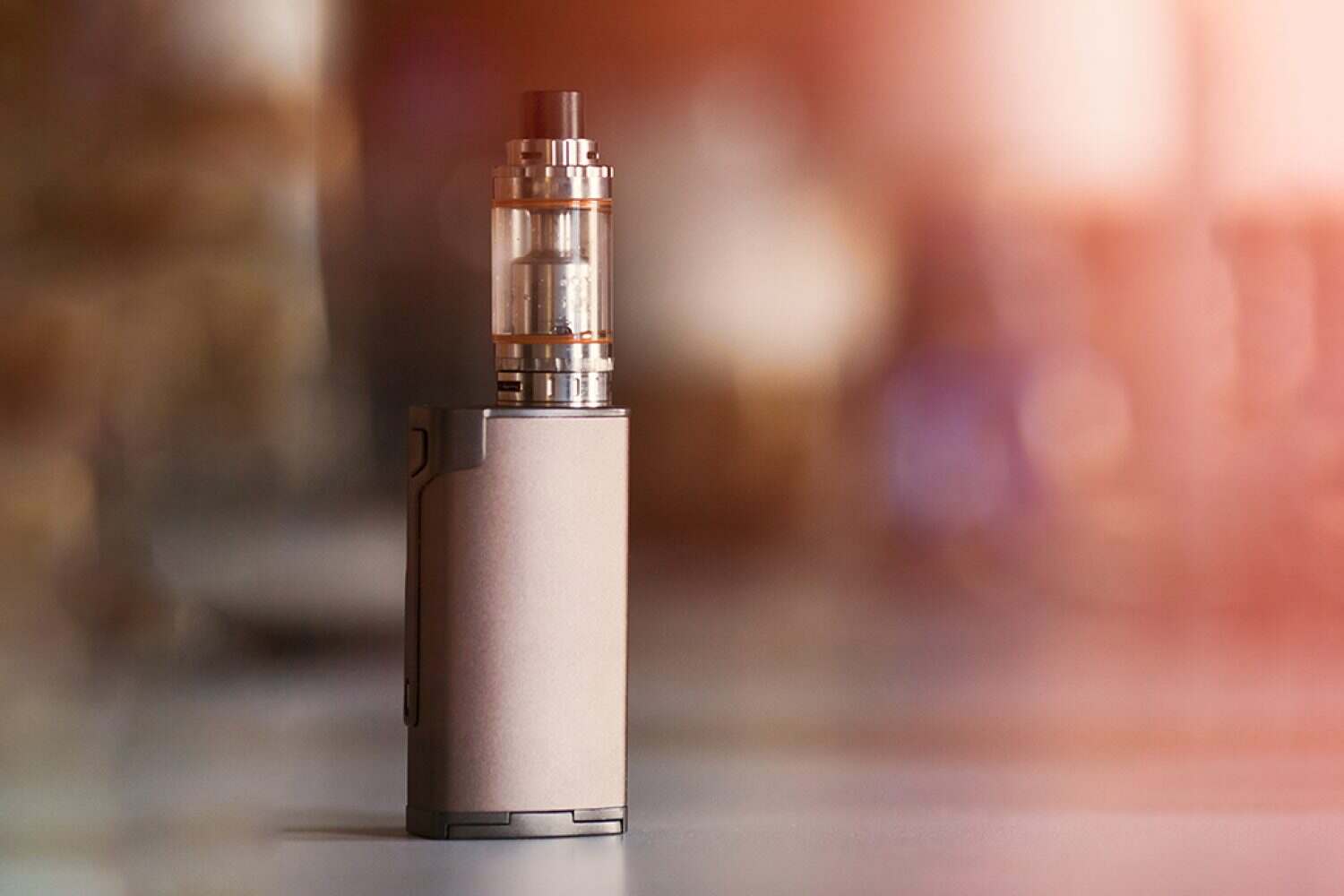 vape, electronic cigarette. blurred background. vape, electronic cigarette. blurred background. Popular smoking gadget to people who want to quit smoking nicotine cigarettes and start vaping safe glycerin vape.Trendy electronic cigarette or ecig.